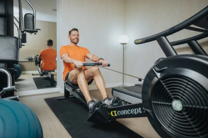 Man in sportswear exercising on a rowing machine.