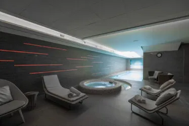 The spa relaxation area, with armchairs and loungers in the foreground.